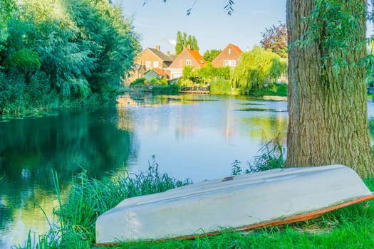boat upside down on the bank of a big pond water landscape