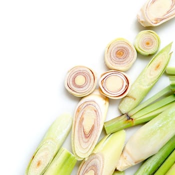 Fresh green lemongrass slices with copy space, isolated on white background.