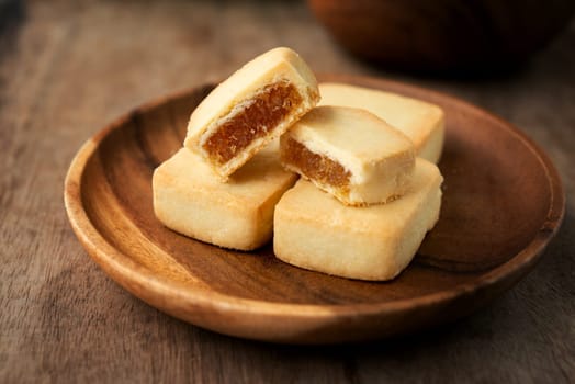 Pineapple cake is a sweet traditional Taiwanese pastry containing butter, flour, egg, sugar, and pineapple jam.