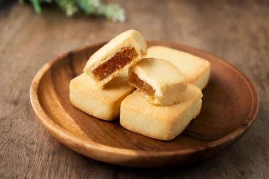 Pineapple cake is a sweet traditional Taiwanese pastry containing butter, flour, egg, sugar, and pineapple jam.