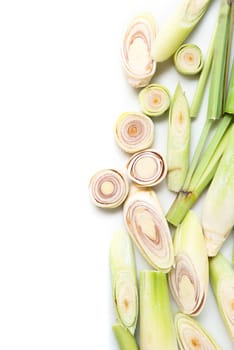Fresh green lemongrass slices with copy space, isolated on white background.