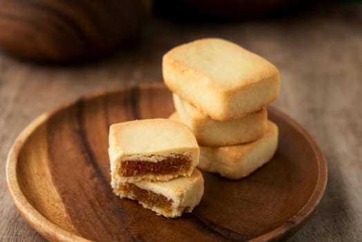 Pineapple cake is a sweet traditional Taiwanese pastry containing butter, flour, egg, sugar, and pineapple jam.