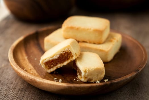 Pineapple cake is a sweet traditional Taiwanese pastry containing butter, flour, egg, sugar, and pineapple jam.