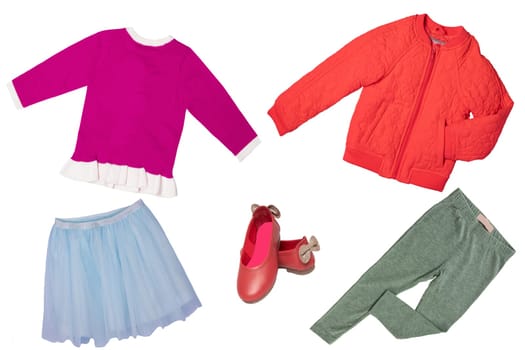 Top view on child girl set of clothes. Collage of apparel clothing. Skirts, sneaker, jacket, shirt and trousers isolated on a white background. Summer fashion.