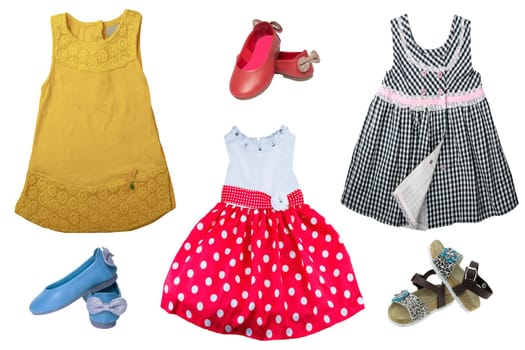 Top view on child girl set of clothes. Collage of apparel clothing. Skirts and sneaker or shoes isolated on a white background. Summer fashion.