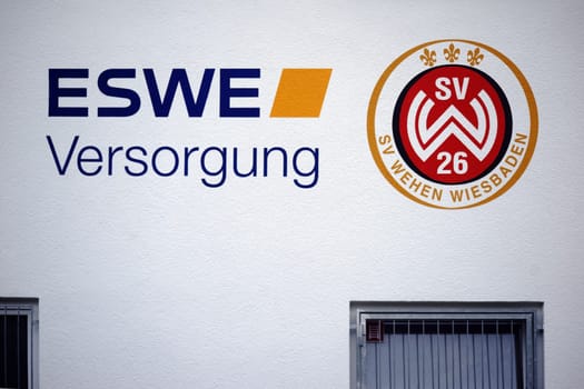Taunusstein Wehen, Germany - October 07, 2018: The coat of arms of the sports club SV Wehen Wiesbaden and an advertising medium on the facade of a club building on October 07, 2018 in Taunusstein-Wehen..