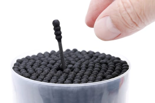 Black cotton swabs with the finger on the white background