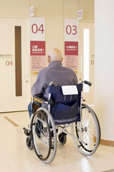Back view of senior or elderly man sitting on wheelchair in hospital