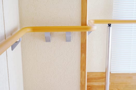 Walkway in the building with railing on white wall
