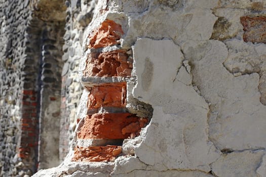 A damaged, broken corner on a house wall.
