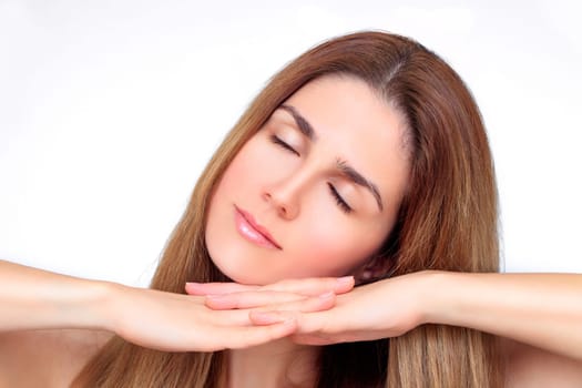 Beautiful face of a woman with hands under her chin