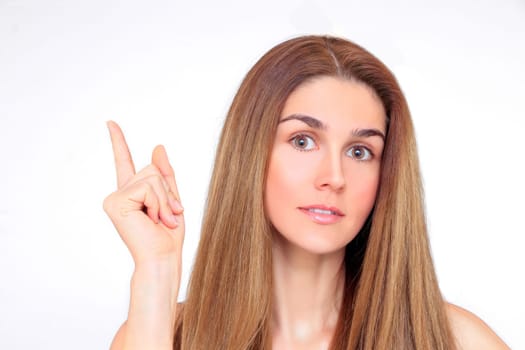 Beautiful woman with index finger looks up