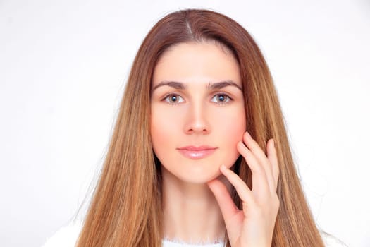 Beautiful face of a woman with hands under her chin