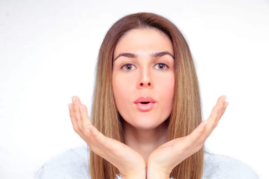 Beautiful woman with closed eyes meditates with her hands in front of her face