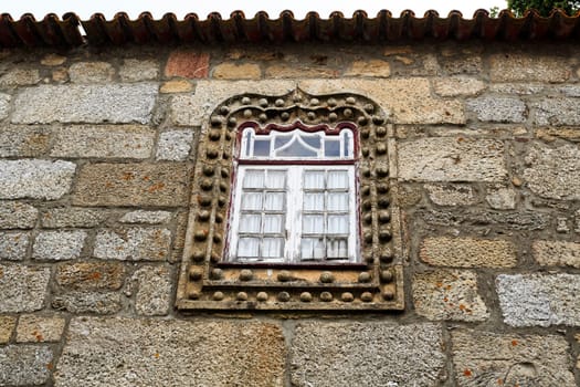 Manueline style window in the narrow streets of the medieval village of Linhares da Beira, Gouveia, Portugal