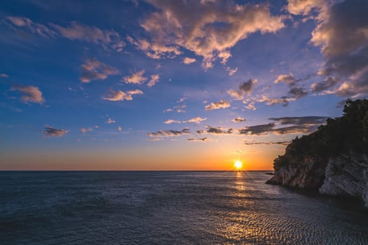 Beautiful sunset over the cliffs in Petrovac coast, Montenegro