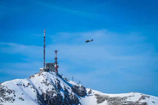 Helicopter flying above telecommunication station on the Stirovnik peak, the highest summit of the Lovcen National Park, Montenegro