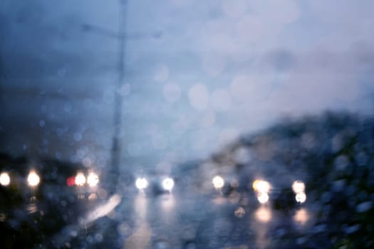 Traffic in heavy rainy day with road view inside the car window with rain drops bokeh.