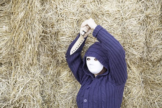 Masked woman in barn farm, halloween