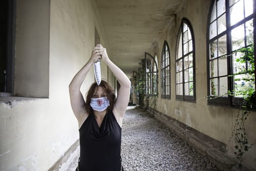 Psycho girl with knife and medical mask