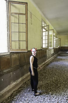 Clown in abandoned house and ruined halloween