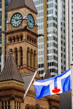 Toronto blue flag waving in front of Old City Hall in Ontario, Canada