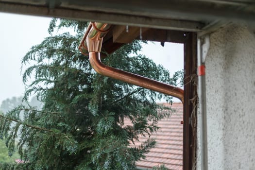 A new gutter, drain, made of copper.