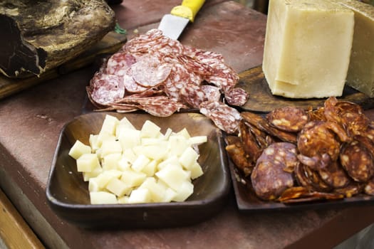 Cheese and sausage cut into a plate, cured meat and lunch