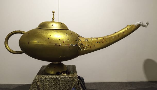 Magic golden aladdin lamp, decorative objects and fantasy