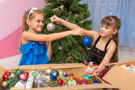 Sisters show each other Christmas balls