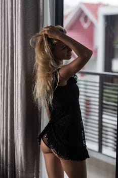 Beautiful woman posing at the window