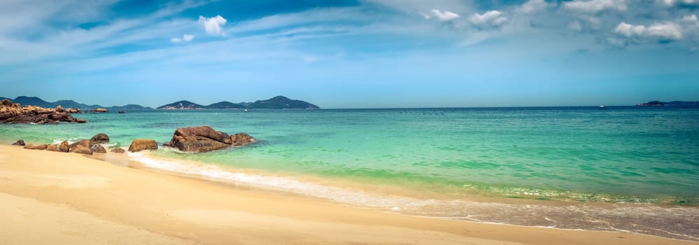Beautiful white sand beach. Stones on a foreground. Landscape of Vietnam. Panorama