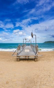 Scenic view of Nha Trang beach at sunny day. Beautiful tropical landscape. Pier on the foreground