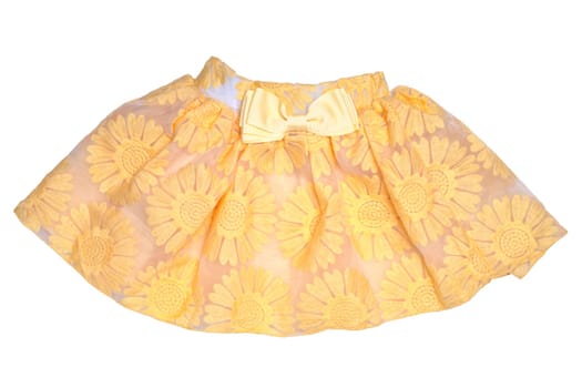 Girls clothes. Festive beautiful yellow little girl short summer skirt with floral pattern and a golden ribbon bow isolated on a white background. Children and kids fashion.