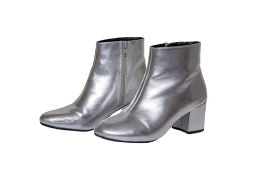 Womens boots and shoes. A pair female silver boots isolated on a white background. Leather shoe fashion new collection 2019.