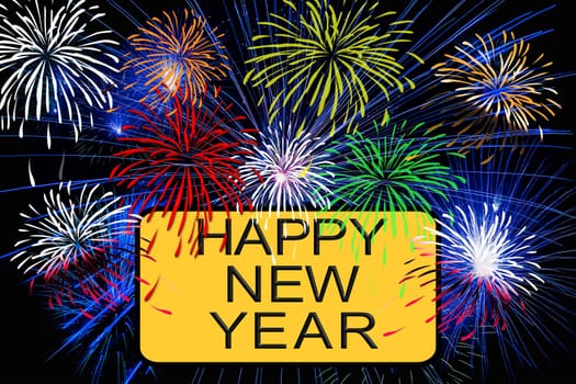 Happy new year text on yellow sign with fireworks in the night sky
