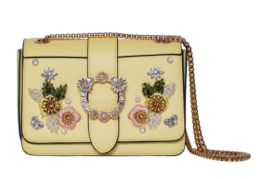 Fashionable yellow female luxury women bag isolated on a white background. Fashionable womans accessories.