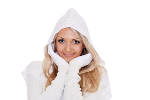 Young happy beautiful woman in winter clothes stands on a white background.