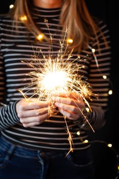 Girl hands holding burning sparklers