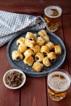 Savoury snack with puff pastry and sausages / pigs in a blanket