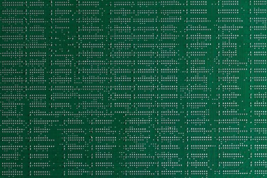 Computer technology background. Close up of green digital electronic printed circuit board. Solder side. Macro of a PCB.