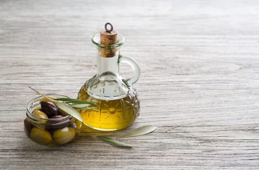 Bottle of Extra virgin healthy Olive oil with fresh olives close up