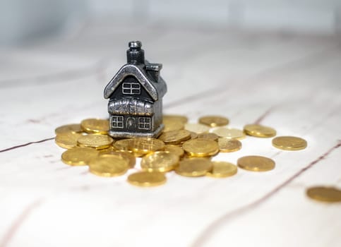 The house stands on a pile of coins, the concept of cash savings, loans..