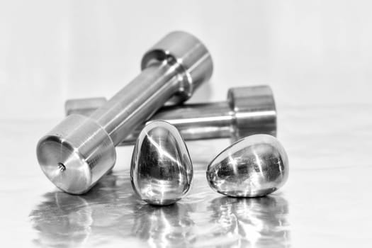 Metal dumbbells and steel eggs, the concept of sports training and the achievement of muscle strength.