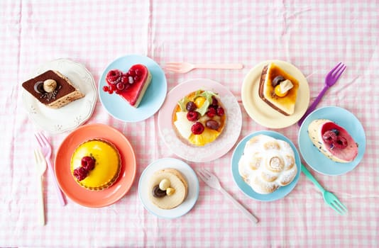 Delicious little cakes and pies on colorful plates