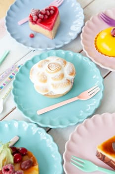 Delicious little cakes and pies on colorful plates