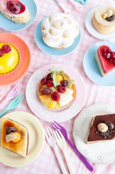 Delicious little cakes and pies on colorful plates
