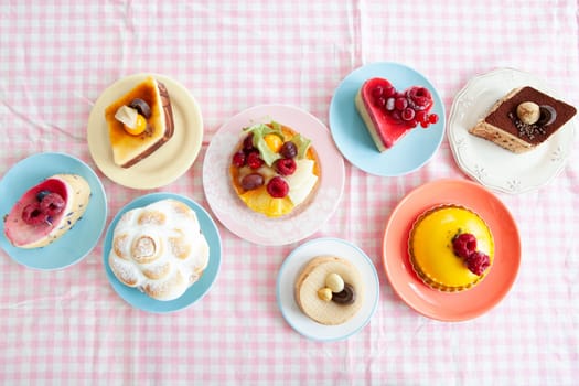 Delicious little cakes and pies on colorful plates