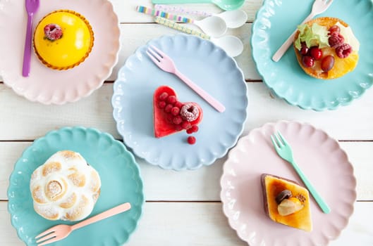 Delicious little cakes and pies on colorful plates