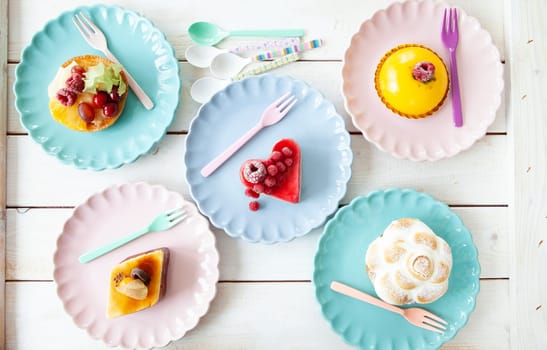 Delicious little cakes and pies on colorful plates